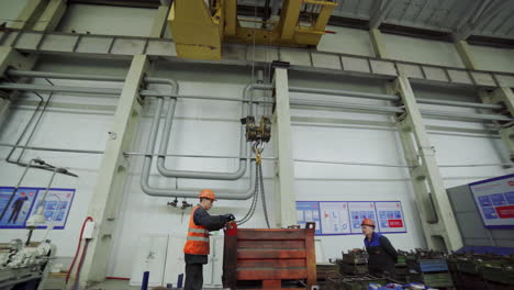 factory workers operating heavy equipment