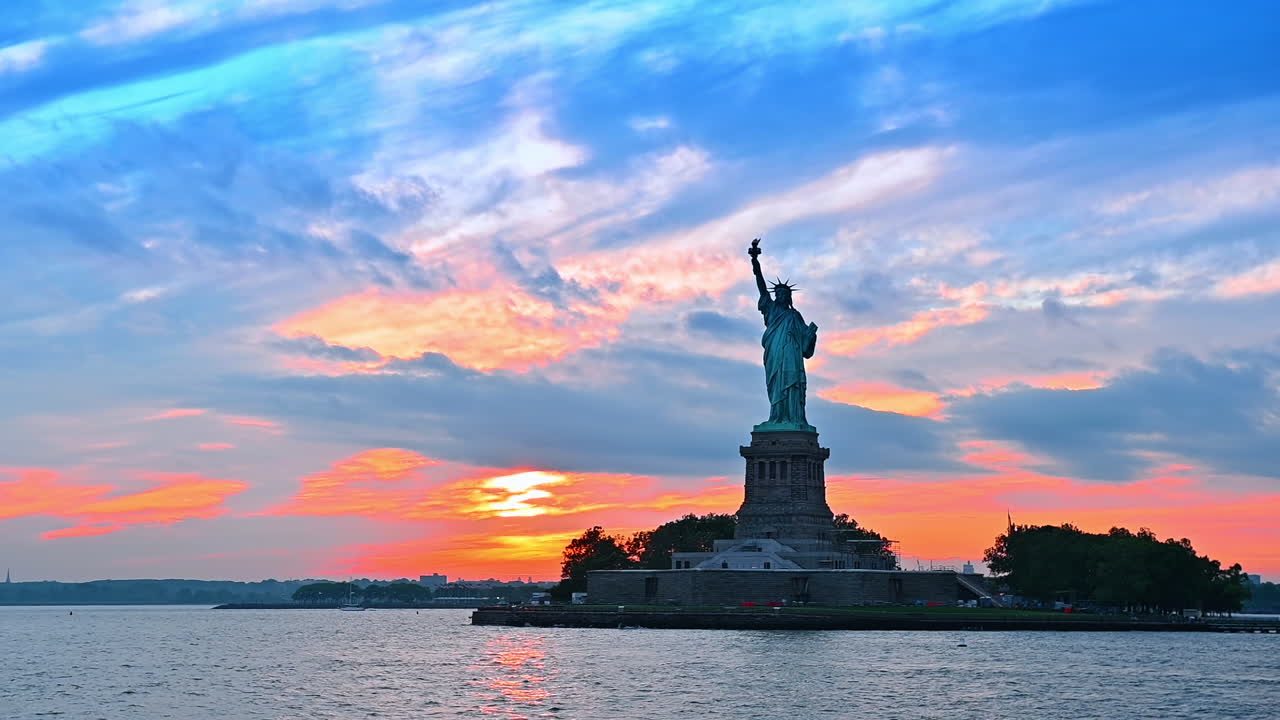 Statue of Liberty on the Liberty Island. View on the American landmark from the river at sunset