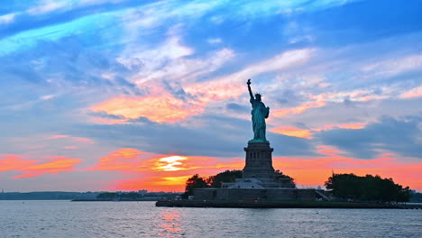 statue of liberty on the liberty island. view on the american landmark from the river at sunset
