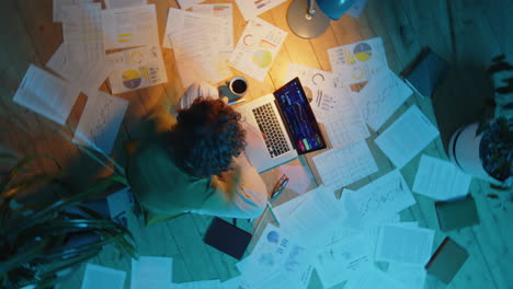 female freelancer working on investment plan during night