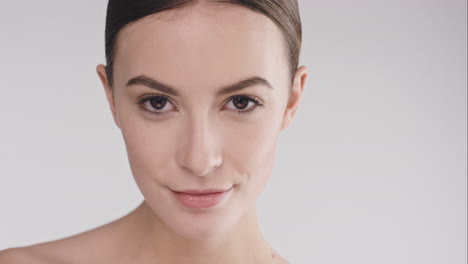 Beauty-portrait-of-woman-with-beautiful-face-tilting-head-up-slow-motion-skincare-concept-on-a-grey-background-slow-motion-Red-Epic-Dragon