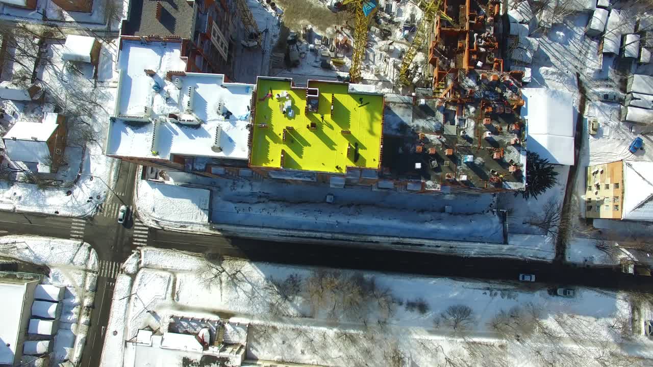 Construction of modern building. Aerial view of high construction building with cranes