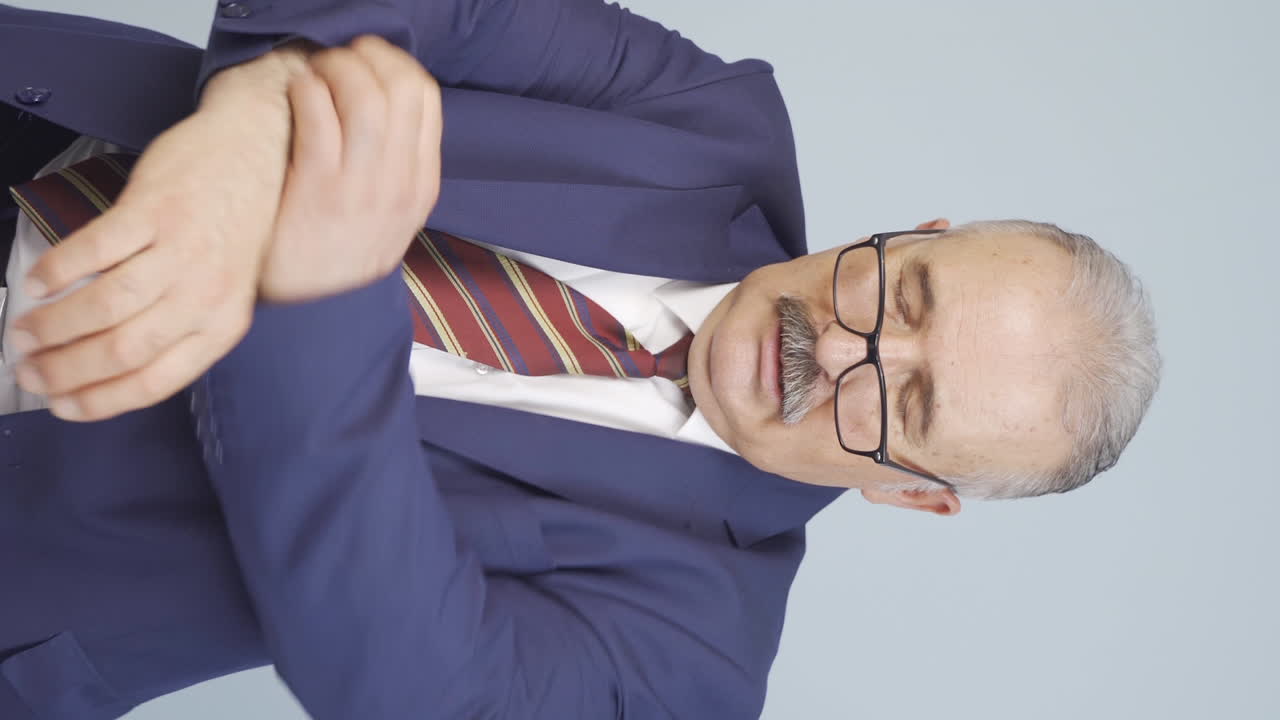 vídeo vertical de un viejo hombre de negocios con picazón.