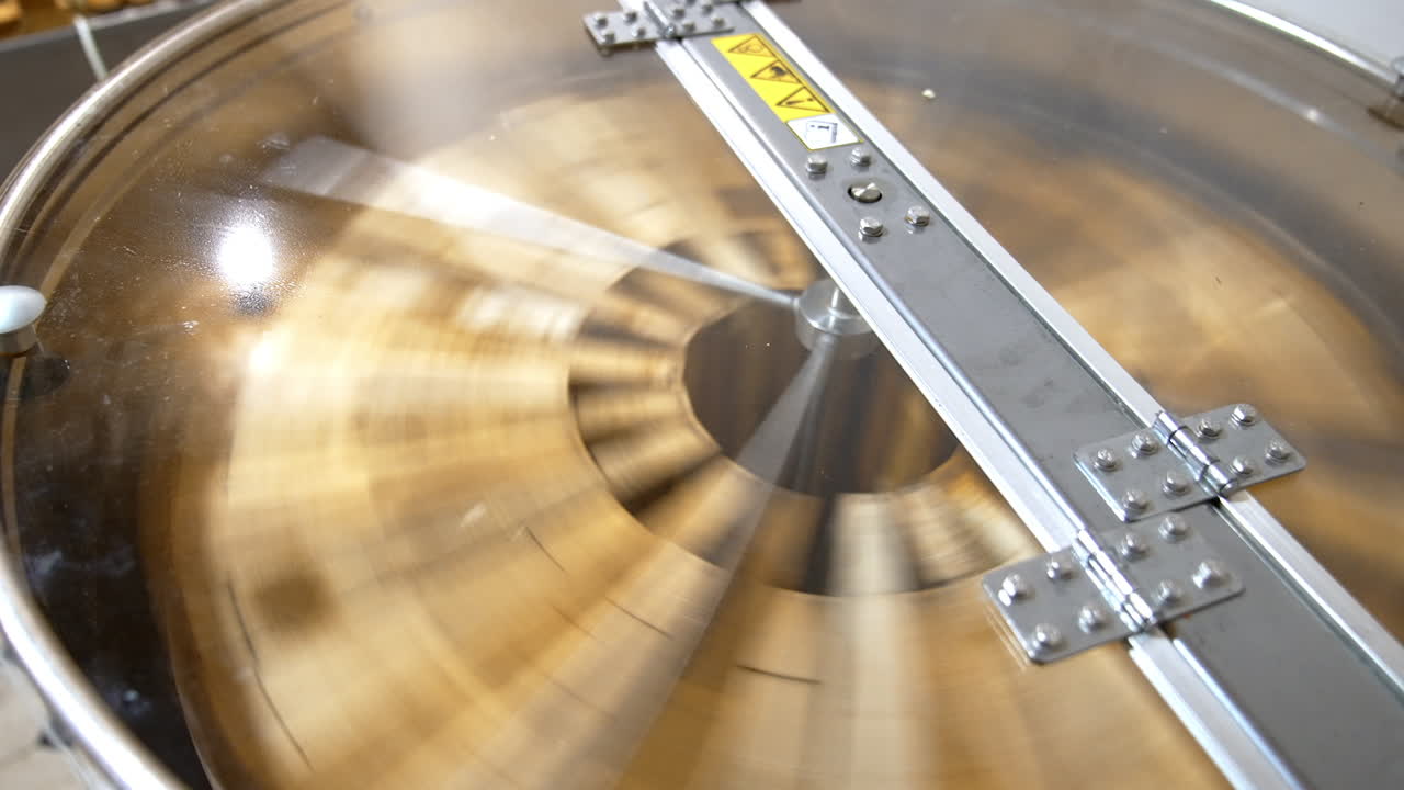 Centrifuge device working. Honey frames being rotated inside the apparatus for extracting honey harvest. Close up.