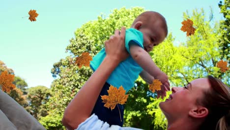 Animation-of-falling-yellow-over-caucasian-mother-and-baby