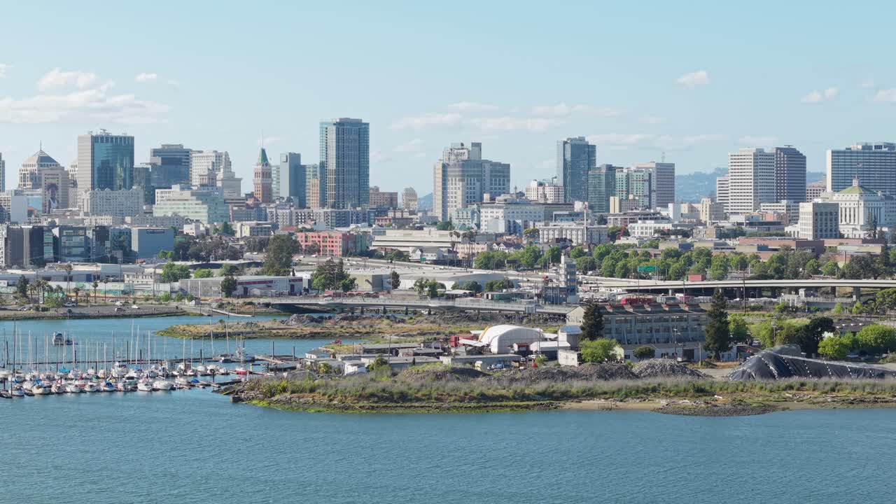 Static drone footage displays Jack London Square’s marina, bustling walkways, and nearby industrial piers, capturing the area’s mix of recreation and maritime heritage