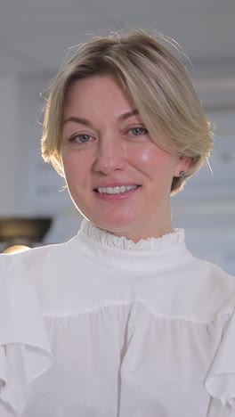 Attractive Middleaged Blond Woman with a Beautiful Smile Looking Directly at the Camera. Attractive middle-aged blond woman with a beautiful smile looking directly at the camera