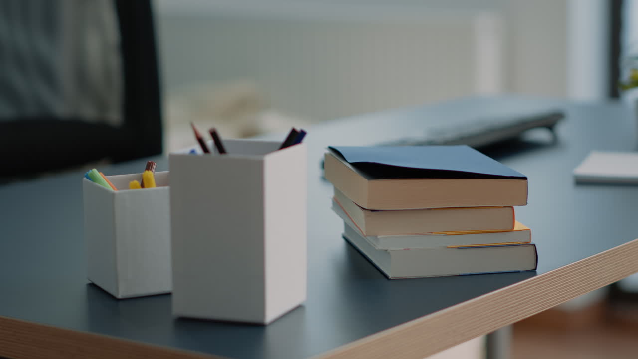 Close up of books and computer with keyboard on desk