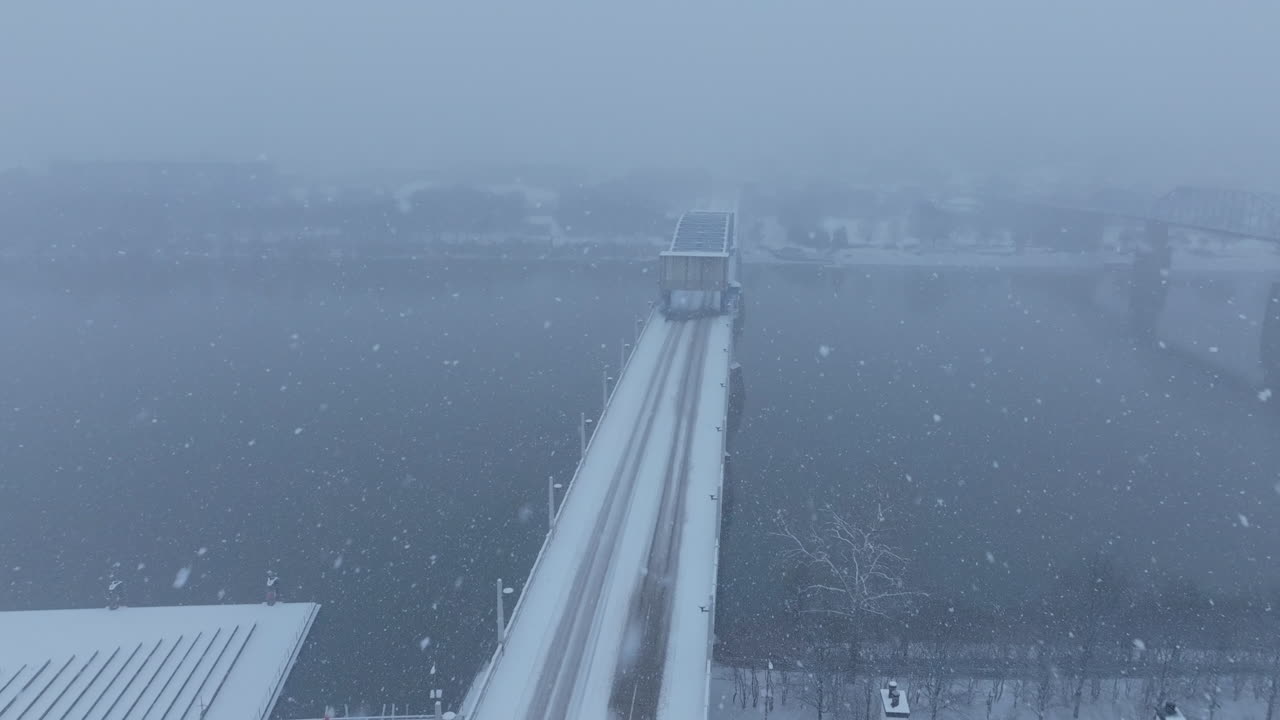 Aerial footage flying over the Market Street Bridge in Chattanooga, TN during a snowstorm.