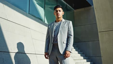 portrait of a young man in a suit outdoors