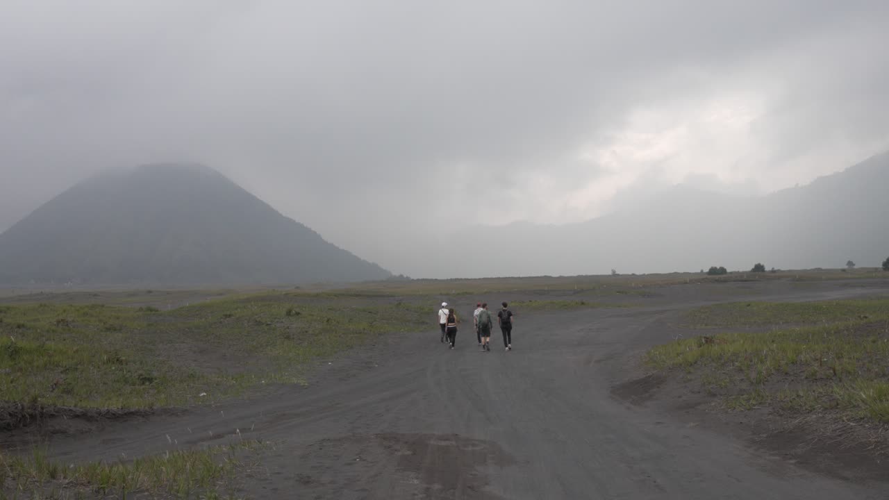 Bromo active volcano crater grey landscape Java island group of people excursion trip Indonesia