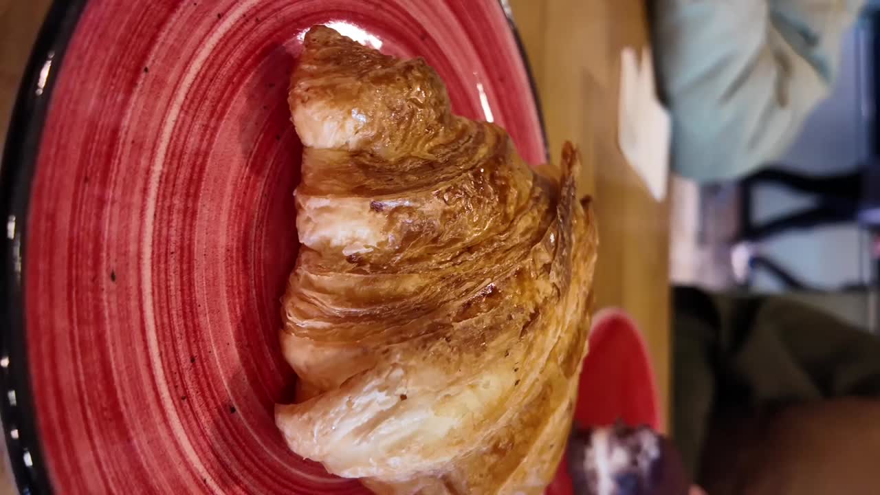 Croissant on a red plate