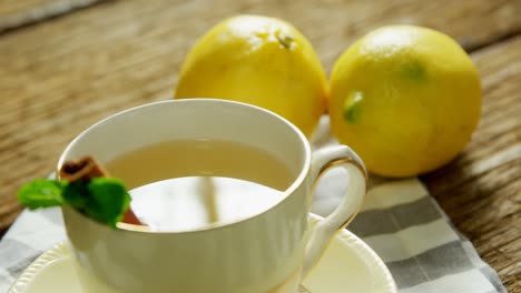 Herbal-tea-with-cinnamon-sticks,-herb-and-lemon-4k