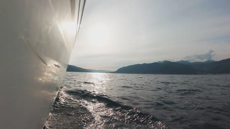 boat on the water with mountains in the background