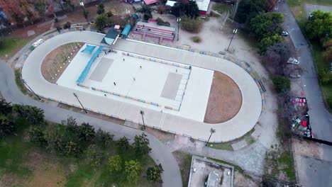 aerial view of several people skating on a smooth white rink