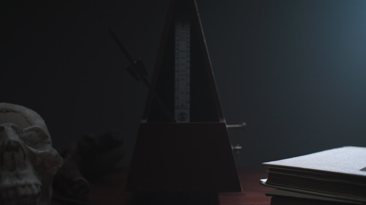 Metronome set the rythm in the dark, old room