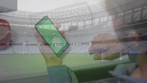 animation of man holding smartphone with covid 19 vaccination passport over stadium