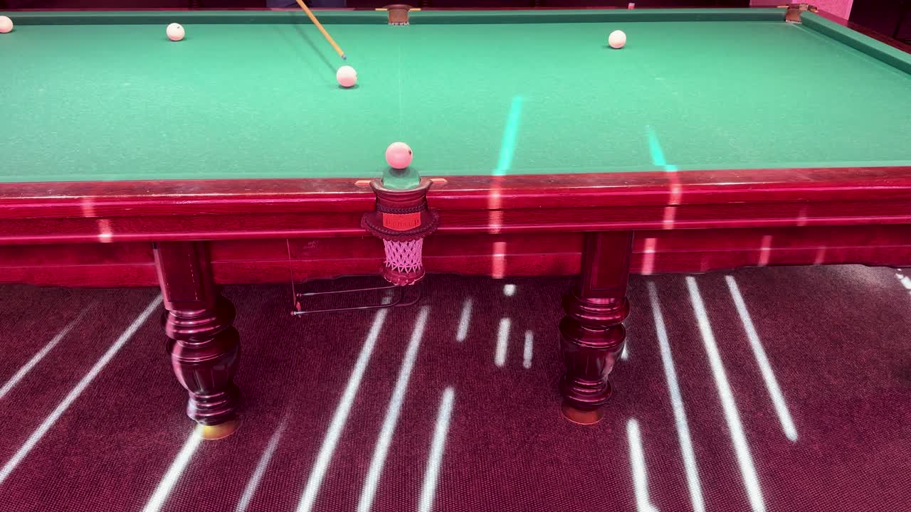 Billiard pyramid game table and ball shot in a Chisinau, Moldova club, showcasing indoor leisure