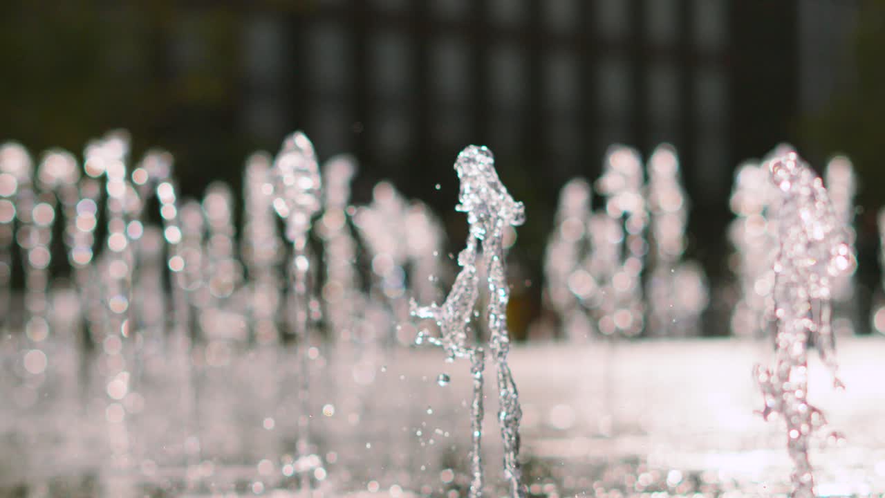 Close Up of Beautiful Abstract Water Fountain Creating Patterns with Shallow Depth of Field. Granary Square Fountains in London
