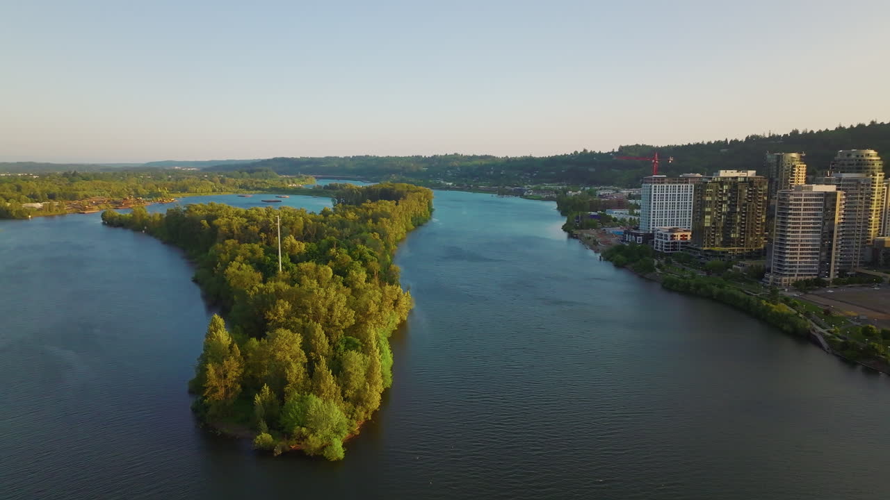 Beautiful twilight aerial of Portland, Oregon's Willamette River and south waterfront. Wide shot, camera flies forward and pans right.