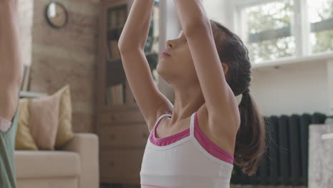 madre e hija practicando yoga en casa