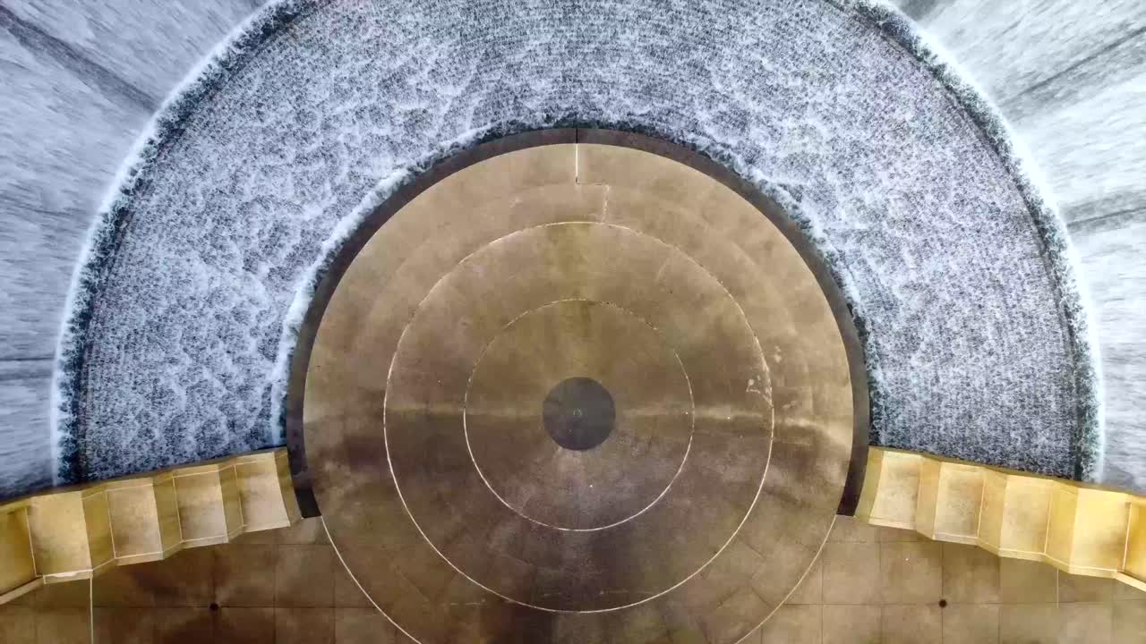 An overhead view of Houston's Waterwall, in the midst of trees, at 60 frames