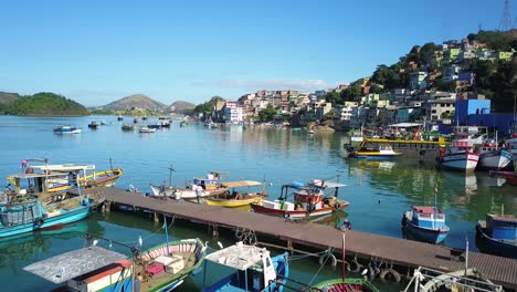 drone crossing a pier full of boats in a beautiful sunny day - vitória, espírito santo brazil