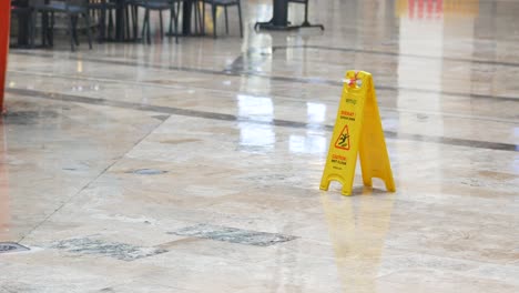 wet floor caution sign in shopping mall