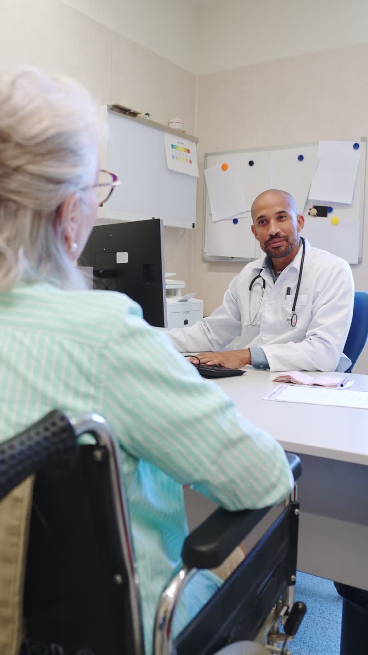 Doctor consulting with patient in wheelchair