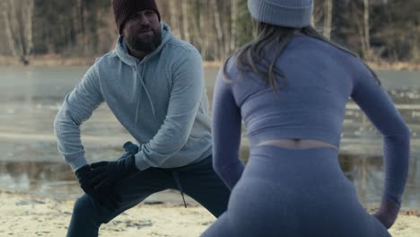 Adult-caucasian-couple-chatting-and-warming-up-before-winter-swimming.