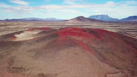 spectacular aerial over red ash topped volcanoes and lava flows in the remote highland interior of iceland 1