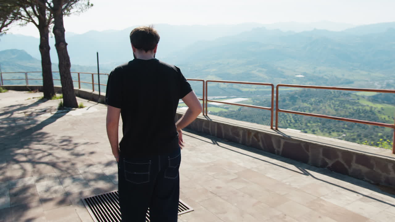 Man Walking on a Mountain Viewpoint