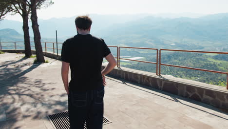 man walking on a mountain viewpoint