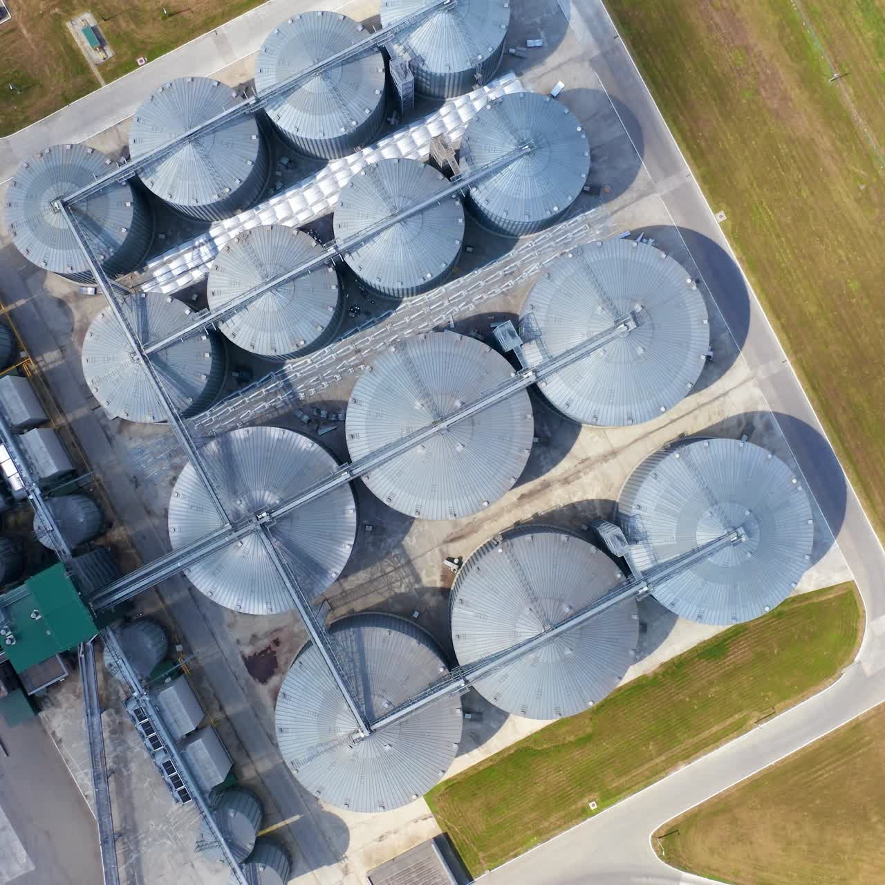 Warehouse granary aluminum containers. Grain silo and parking place. Steel grain elevators. Agriculture Industry. Top view