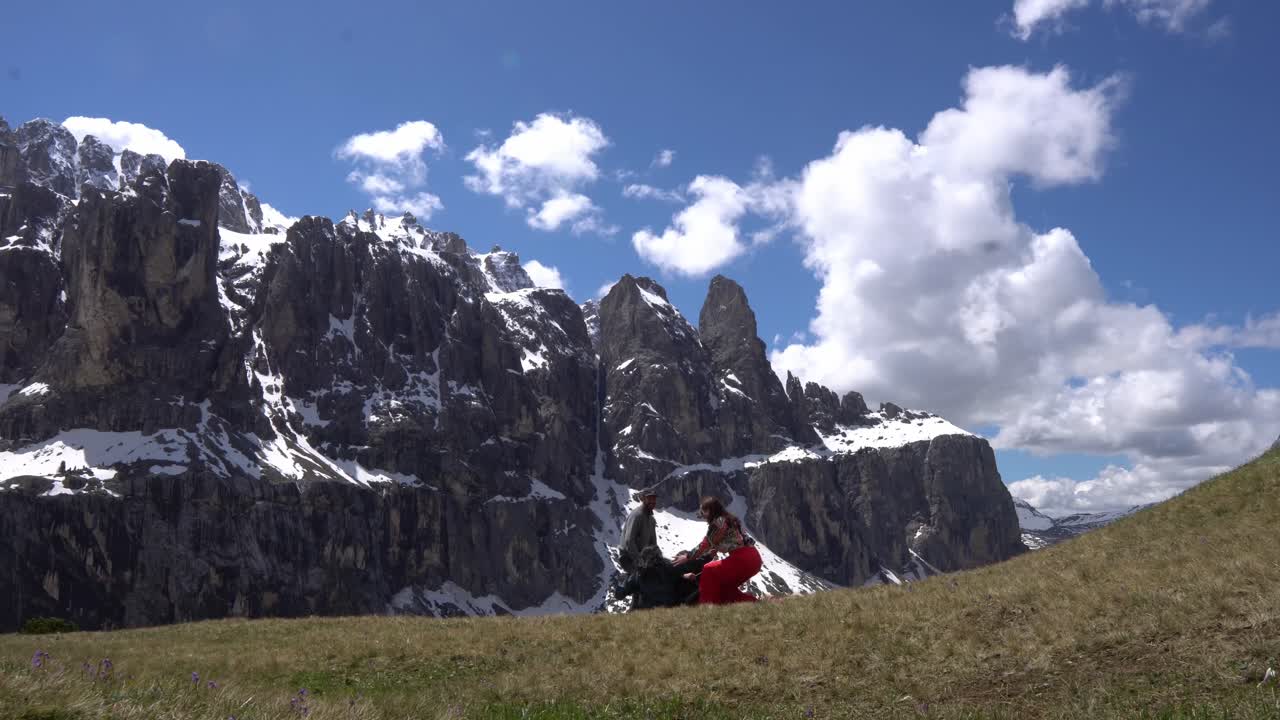 Happy Tourists Enjoying Scenic Views In Dolomites, Italy - Wide Shot