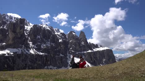 happy tourists enjoying scenic views in dolomites, italy - wide shot
