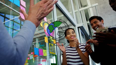 animation of drawn globe over diverse creative colleagues clapping at casual office meeting