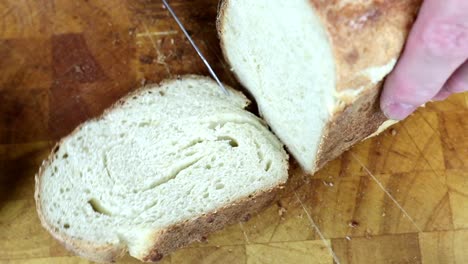 slicing a freshly baked sourdough bread