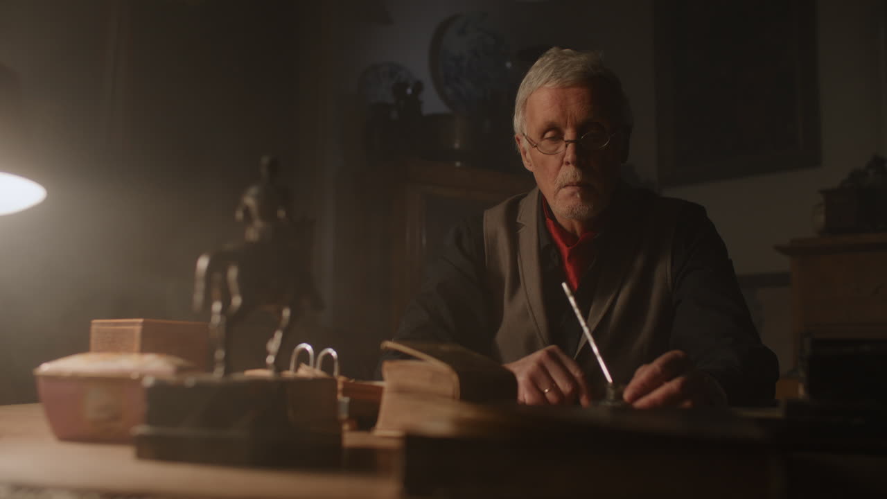 Old passionate man look to the old book in his office at night