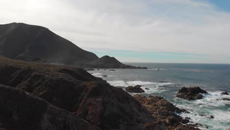 Waves-crashing-near-rocky-coastline-cliffs