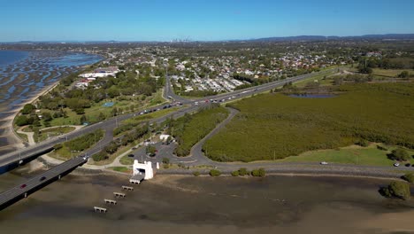 Left-to-right-aerial-view-over-the-Houghton-Highway-Bridge-and-Brighton,-Brisbane-Australia