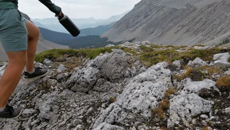 hiker walking trough mountain view pond rockies kananaskis alberta canada