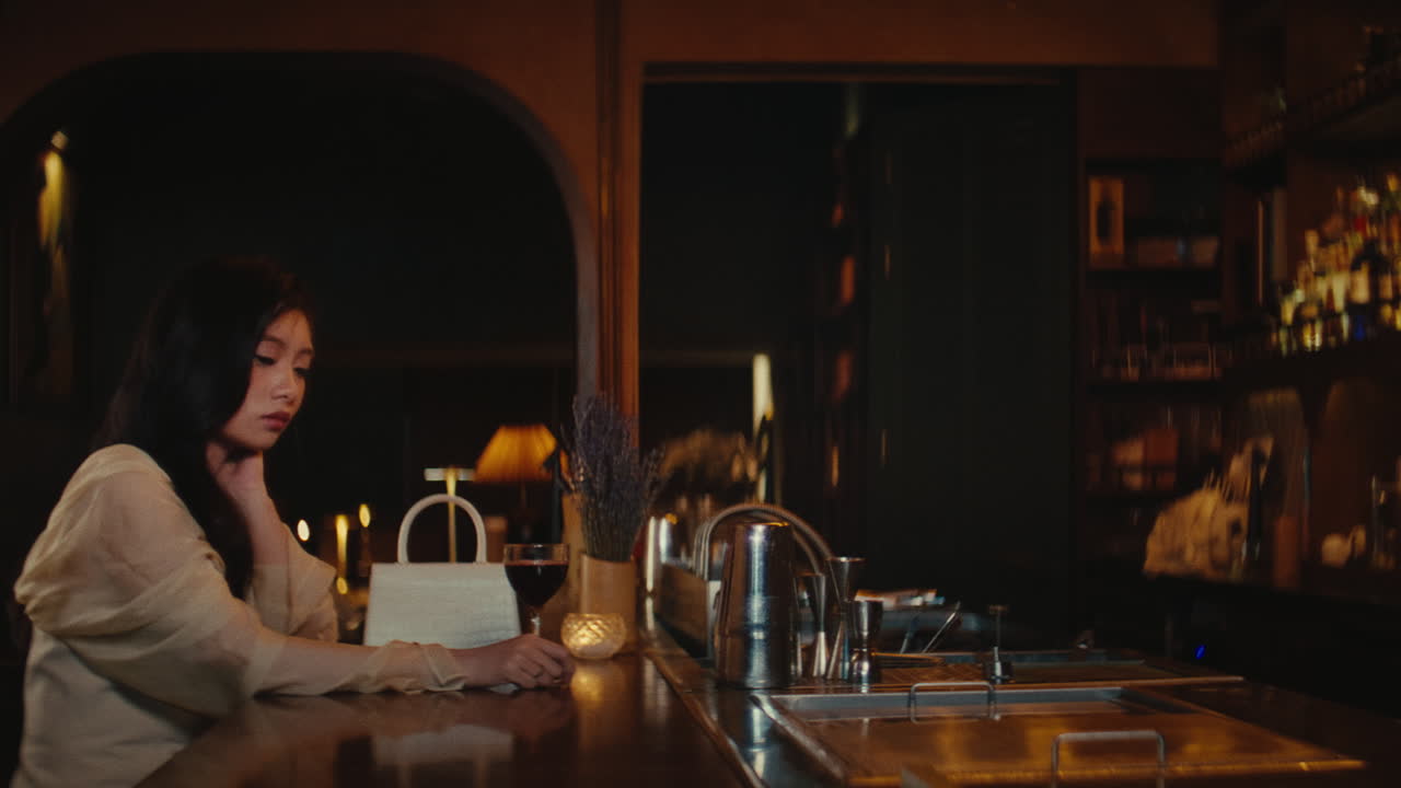 Woman at a dimly lit bar