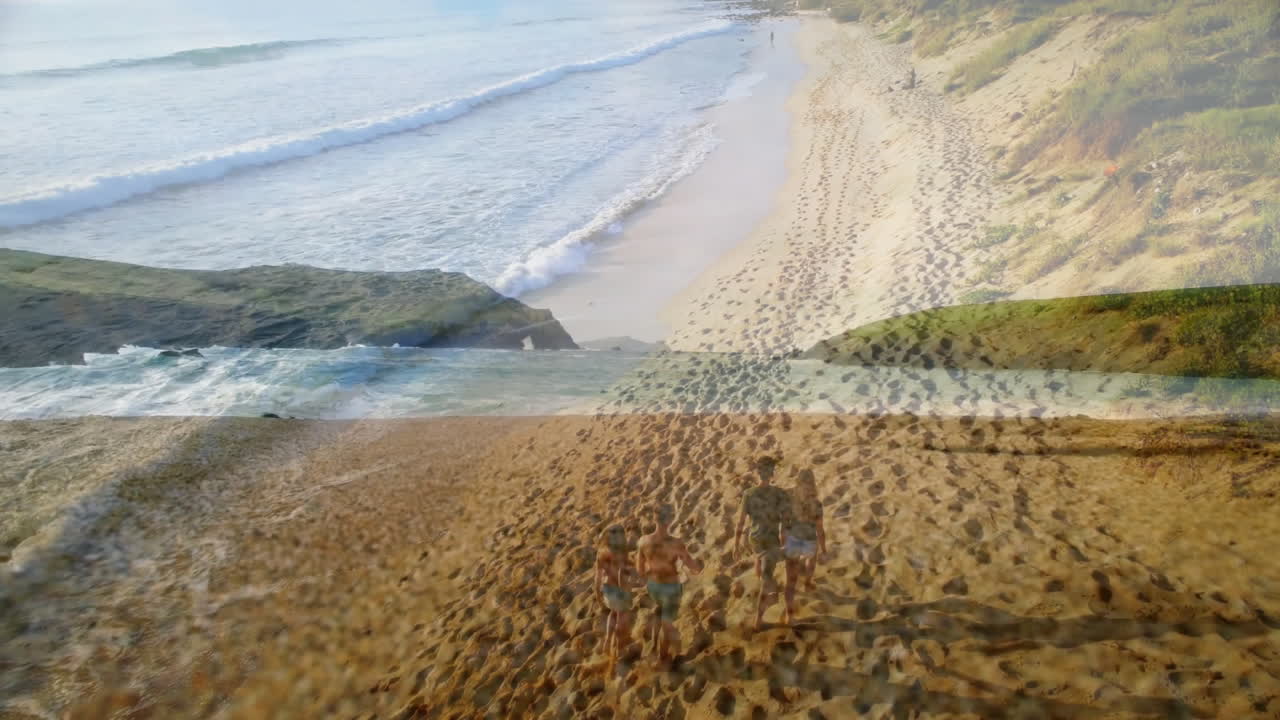 Walking along sandy beach, people enjoying ocean waves with cliffs in background