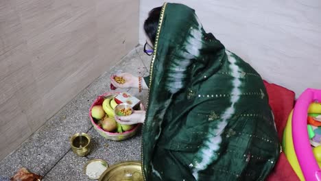 indian women doing holy rituals at home for children's wellbeing from different angle on the occasion of jitiya vrat or nirjala vrat in india