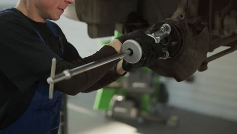 team of mechanics repairing car suspension