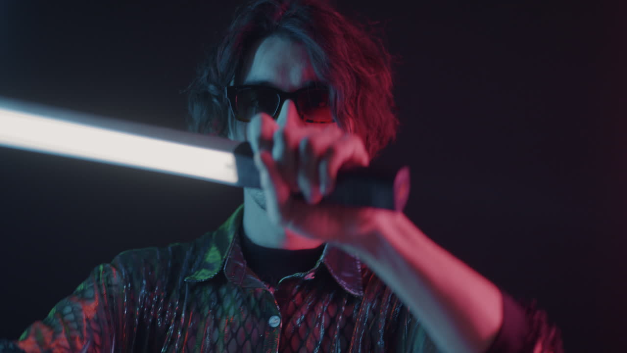 Man with Lightsticks in Neon Lighting