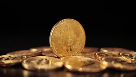 gold bit coin btc cryptocurrency coins on a black background. bitcoin is a worldwide cryptocurrency and digital payment system called the first decentralized digital currency.