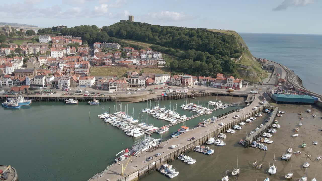 Aerial orbit view of Scarborough town, harbor and castle