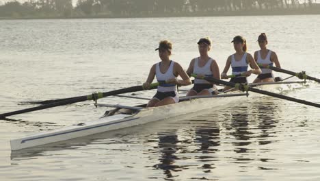 female rowing team training on a river